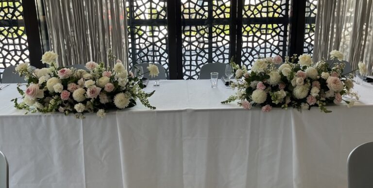 Blush and white arrangements on a bridal table