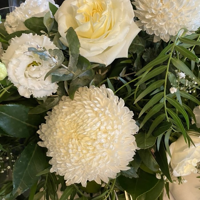 White chrysanthemums, roses and lisianthus with greenery